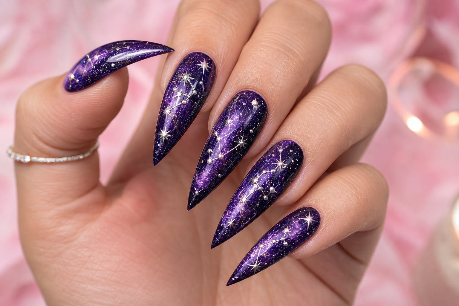 Deep purple galaxy stiletto nails with gold stars