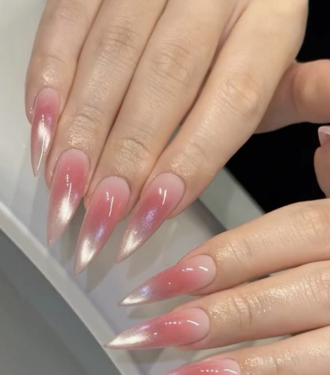 Pink cat-eye chrome stiletto nails with shimmer