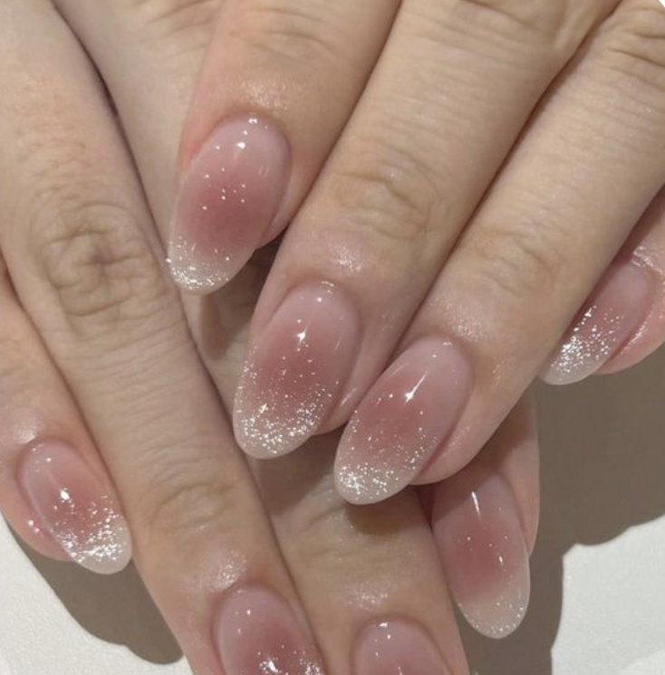 Pink almond nails with white glitter ombre tips