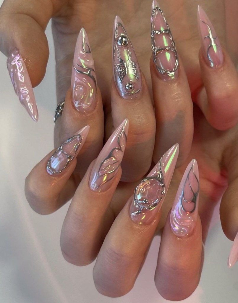 Glossy pink chrome stiletto nails with silver details